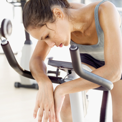 tired woman exercise bike